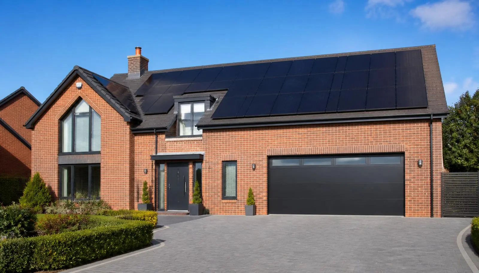Solar panel array installed on the roof of a modern detached home